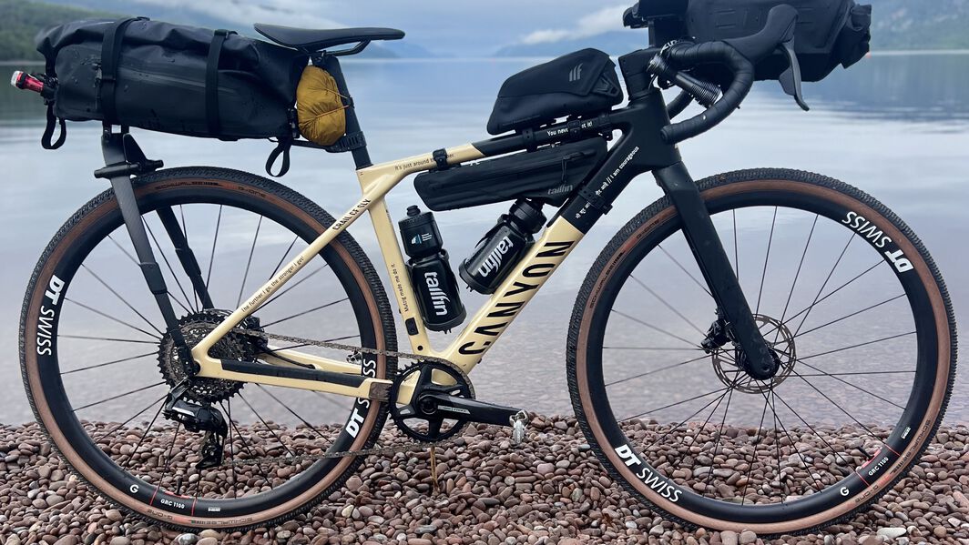 Canyon gravel bike with bikepacking setup—fully equipped with saddle, frame, and handlebar bags for extended off-road adventures.