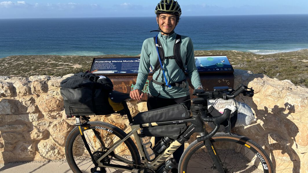 Things to Consider on How to Bikepacking on a Budget – Vedangi Kulkarni’s Expert Tips Vedangi Kulkarni with a fully loaded Canyon bikepacking setup near the coast, sharing tips on how to bikepack on a budget and travel smart